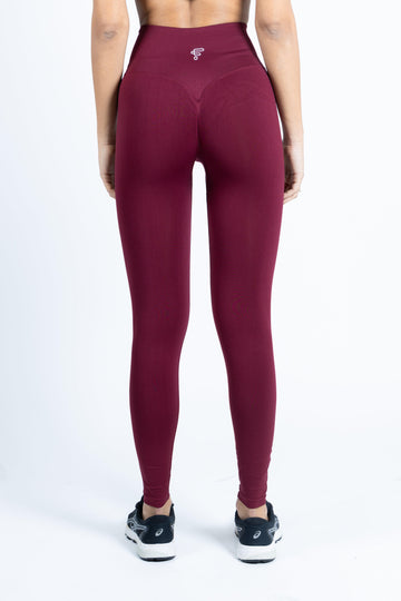 Vista posteriore di un completo activewear seamless color borgogna, con vestibilità aderente.